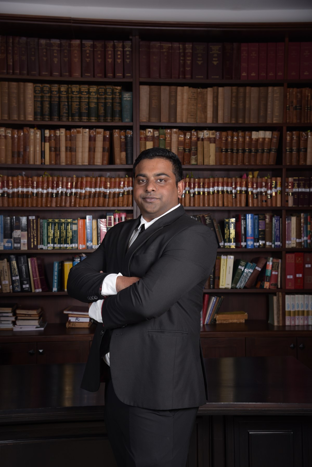 Budwin Siriwardena standing in a law library